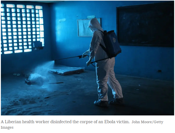 A Liberian health worker disinfected the corpse of an Ebola victim.Credit...John Moore/Getty Images